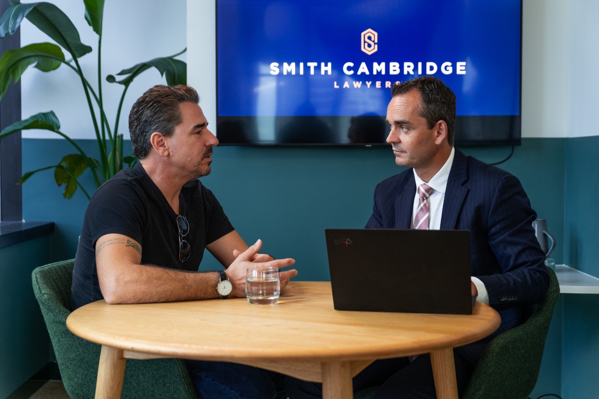 Troy Smith Criminal Defence Lawyer at a table with client, Brisbane law firm